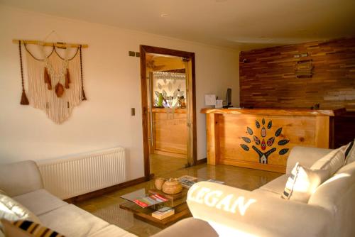 a living room with a couch and a table at Hotel y Cabañas Pulegan in Porvenir