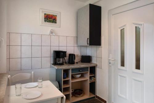 a small kitchen with a table and a counter top at Krüseliner Mühle - Appartements in Krüselin