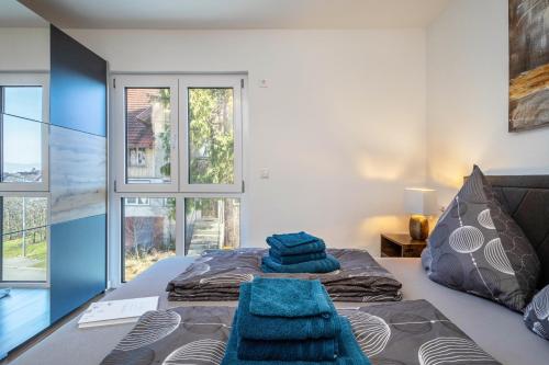 a bedroom with a bed with blue towels on it at Haus Agatha in Wasserburg