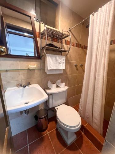 a bathroom with a toilet and a sink at Inca Wasi Plaza de Armas in Cusco