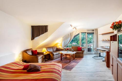 a bedroom with a bed and a living room at Ferienwohnung Weitblick in Bad Liebenzell