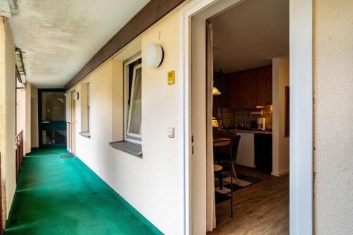 a hallway with a green floor in a house at Ferienwohnung Weitblick in Bad Liebenzell