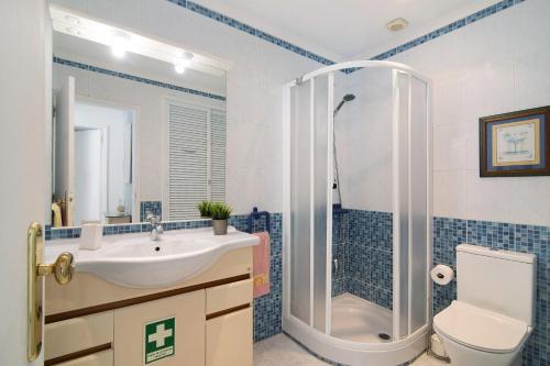 a bathroom with a sink and a shower and a toilet at Lemons Apartment in Carvoeiro