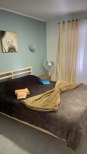 a bedroom with a large bed with a blanket on it at Lemons Apartment in Carvoeiro