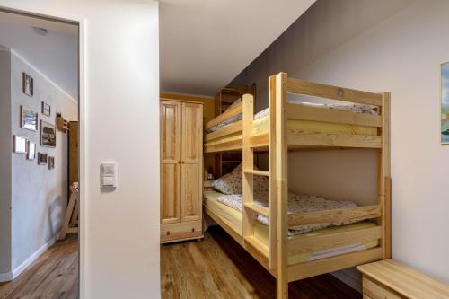 a bunk bed room with two bunk beds at Ferienhof am See in Alt Zeschdorf