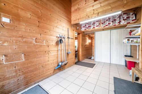 a large room with wood paneled walls and a garage at Chalet Marmottes in Morillon