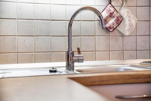 a kitchen sink with a faucet in a kitchen at Apartment Sonnenschein in Mühlbach