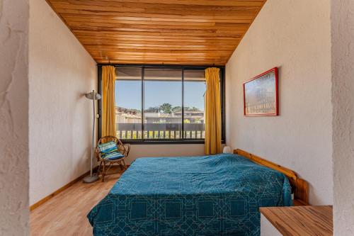 a bedroom with a bed and a window at La Forestière Cap Ferret - Réf 2 in Lège-Cap-Ferret
