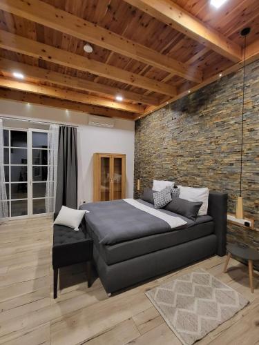 a bedroom with a bed and a brick wall at Hainberg-Loft mit Gartensauna in Mellrichstadt