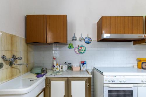 a kitchen with a sink and a counter top at Sartiglia Domu in Oristano