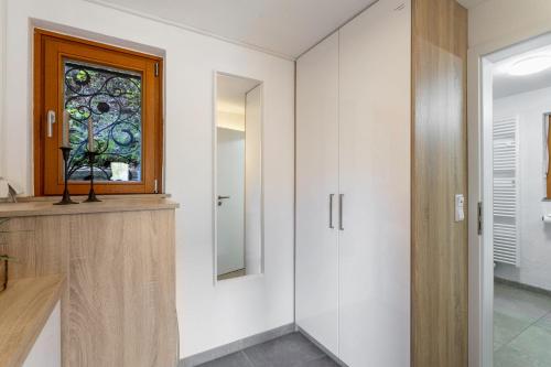 a bathroom with a glass window and a door at Haus Sonnenblick in Diemelsee