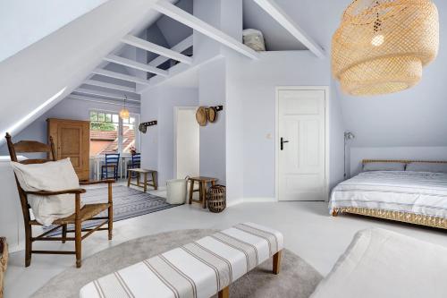 a bedroom with a bed and a table and a chair at Ferienhaus Karinella in Scharbeutz