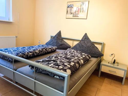 a bedroom with two beds with pillows on it at Ferienwohnung Wadle in Gleisweiler