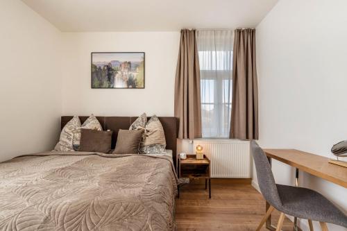 a bedroom with a bed and a desk at Villa Rathmannsdorf in Rathmannsdorf