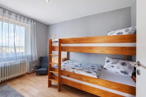 two bunk beds in a room with a window at Baumschule Rombach - 'Spatzennest' in Herbolzheim