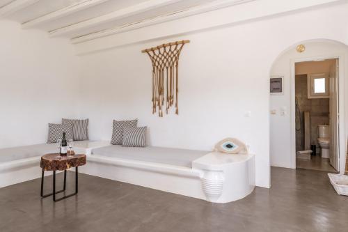 a white room with a couch and a table at Ow Andros Suite 1,Private Whirlpool in Andros