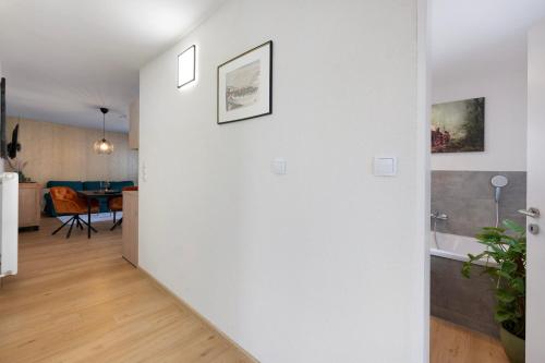 a room with a white wall and a dining room at Baumschule Rombach - 'Spatzennest' in Herbolzheim