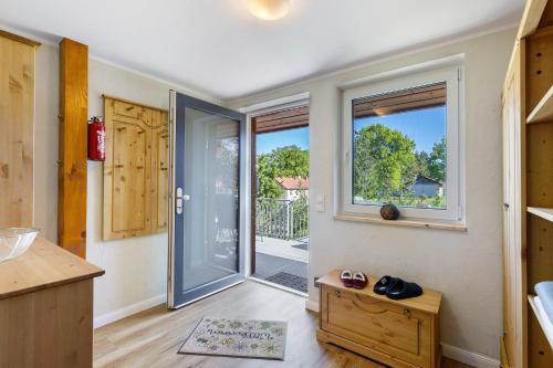 a kitchen with a sliding glass door to a patio at Ferienhof am See in Alt Zeschdorf
