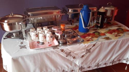 a table with a counter top with a table with a mixer at Lucia Villas Mbale in Mbale