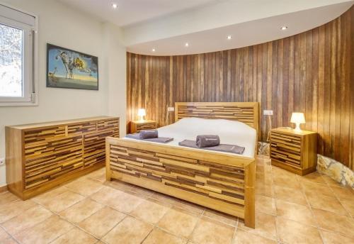 a bedroom with a bed and wooden walls at Costacabana - Villa Nicky in Lloret de Mar