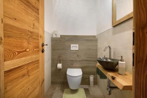 a bathroom with a toilet and a sink at Bergchalet 2 in Freyung