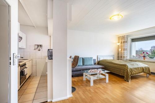 a living room with a couch and a table at Ferienappartement Möhnesee mit Pool in Möhnesee