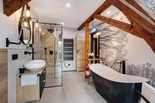 a bathroom with a large tub and a sink at Heimelige Schwarzwaldwohnung Wald in Häusern