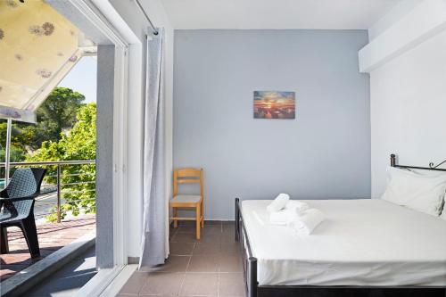 a bedroom with a bed and a balcony at Iguana studio 8 in Preveza