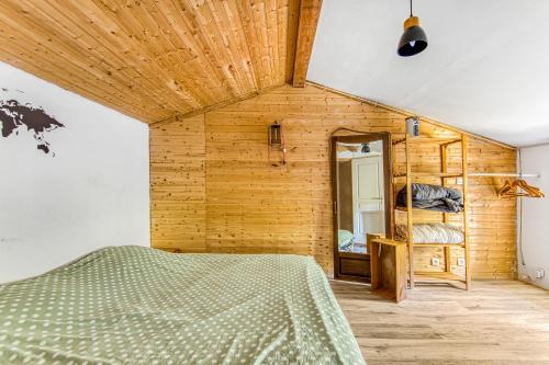 a bedroom with a bed and a mirror at Maison calme d'Amélie in Saint-Germain-dʼEsteuil