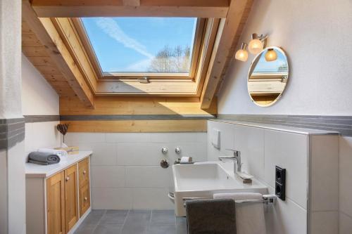 a bathroom with a sink and a window at Ferienwohnung Bergkristall in Grainau