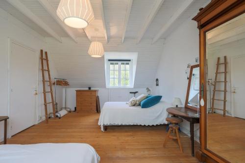 a bedroom with two beds and a desk and a window at L'hermine - Villa de charme in Locquirec