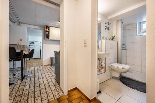 a small bathroom with a toilet and a sink at Tulip Path 3 in Melle