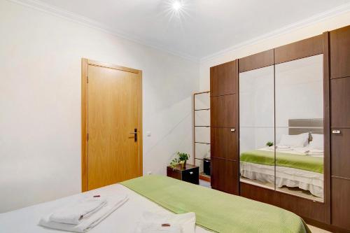 a bedroom with a bed and a large mirror at Casa Monte da Balaia in Olhos de Água