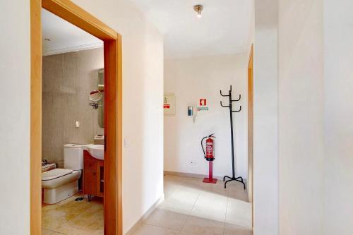 a bathroom with a fire hydrant on the wall at Casa Monte da Balaia in Olhos de Água
