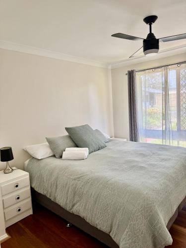 a bedroom with a bed and a ceiling fan at Garlin Corner in Leggs Island