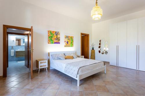 a bedroom with a bed and a chair in it at Casa Altoliva in Marsala
