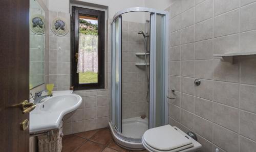 a bathroom with a sink and a toilet and a shower at Villa Lucia in Costa Rei