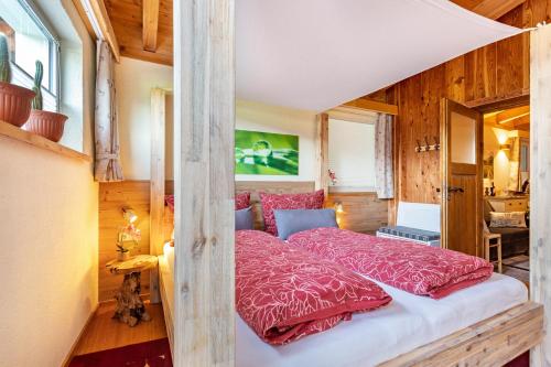 a bedroom with a bed with red pillows at Ferienwohnung Petra Top 3 in Kössen
