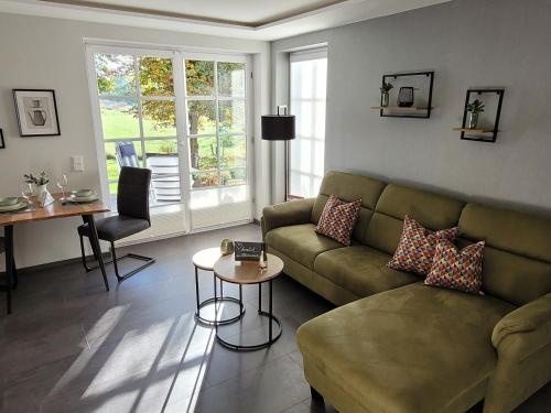 a living room with a couch and a table at Schmallenberger Auszeit in Schmallenberg