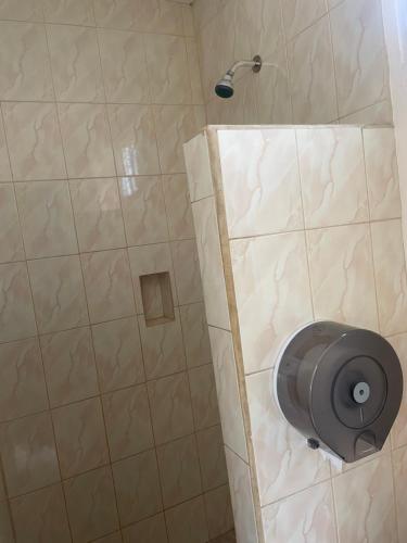 a shower with a shower head in a bathroom at Hotel Ranchito in Ensenada