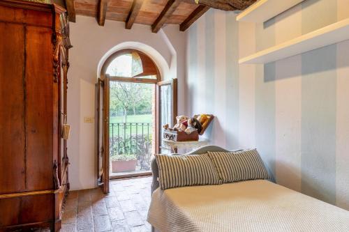 a bedroom with a bed and a window and a door at Greg's House in Santa Lucia