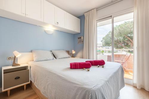 a bedroom with a bed and a large window at Fada Lloret in Lloret de Mar