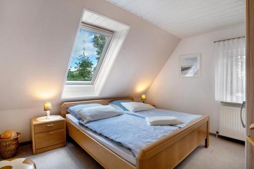 a bedroom with a bed with a large window at Ferienwohnung Simonsen in Rabenkirchen-Faulück