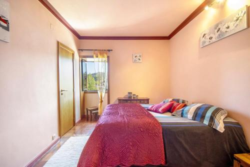 a bedroom with a bed in a room with a window at Porto Douro - Maison in Foz do Sousa