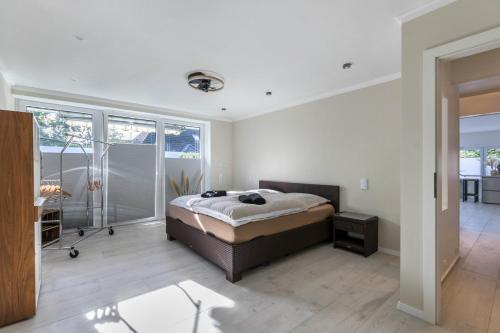 a bedroom with a bed and a walk in shower at Wohnung Deluxe in Heide
