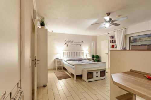 a bedroom with a bed and a ceiling fan at Ferienwohnung Bergidyll in Schmallenberg