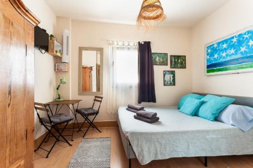 a bedroom with a bed and a table and chairs at Charro Room in Corralejo