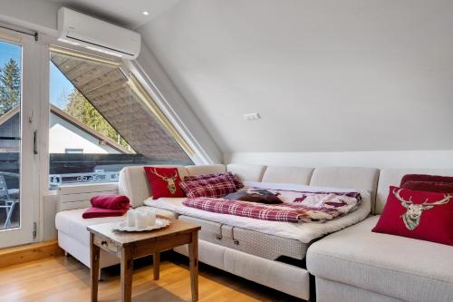 a living room with a couch and a table at Ferienwohnung Hirschsprung Saig in Lenzkirch