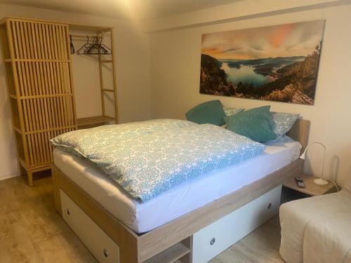 a bedroom with a bed with a painting on the wall at Fewo1 Am Edersee in Edertal