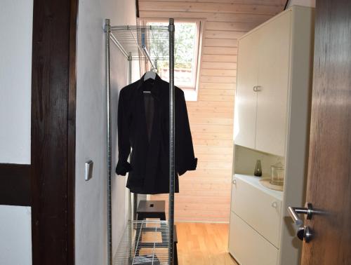 a coat hanging on a rack in a kitchen at Landhaus Bornemann in Diemelsee